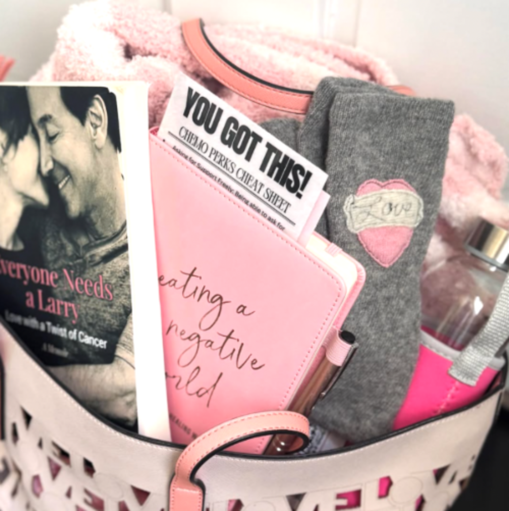 Close-up of a Chemo Love Tote filled with comforting items including a book, mantra cards, cozy socks, and a water bottle—gifted to support cancer patients.
